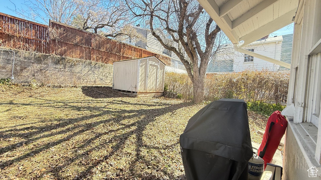 Fenced backyard with a shed and an outdoor structure