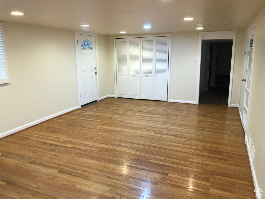 Unfurnished bedroom with recessed lighting, wood finished floors, and baseboards