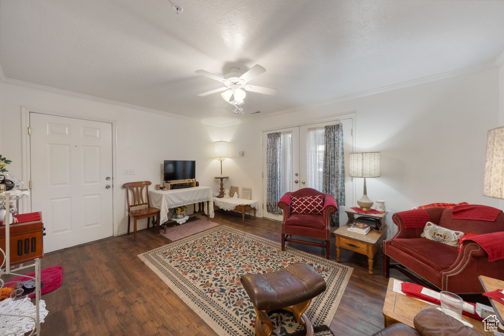 Living room featuring crown molding, ceiling fan, wood finished floors, and french doors