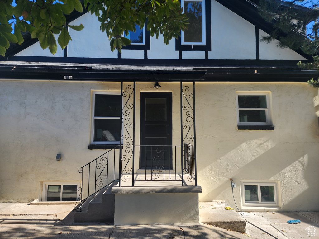 View of exterior entry with stucco siding