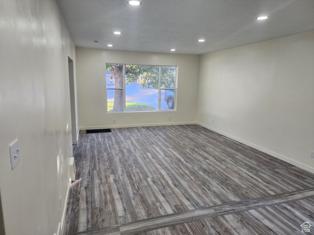 Spare room featuring wood finished floors, recessed lighting, and baseboards
