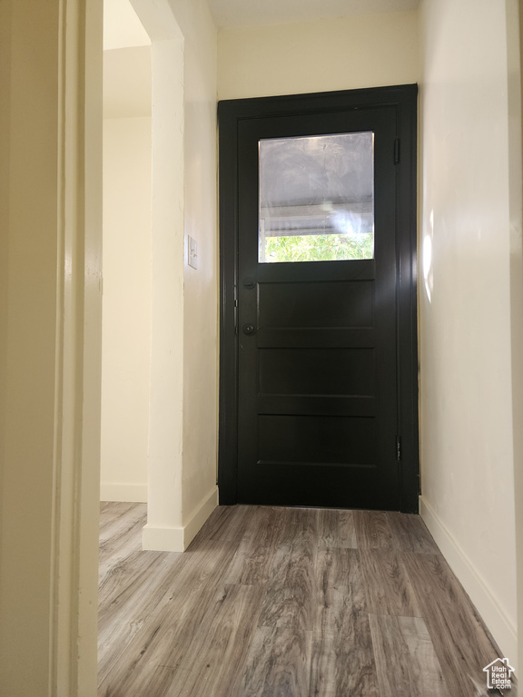 Entryway with baseboards and wood finished floors