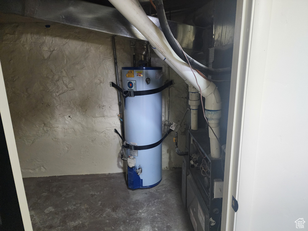 Utility room featuring water heater