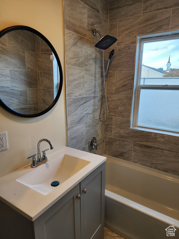 Full bath featuring vanity and  shower combination