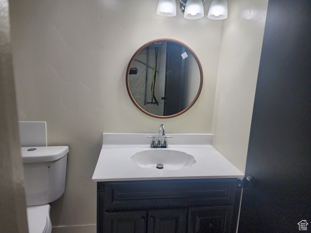 Half bathroom with vanity and toilet
