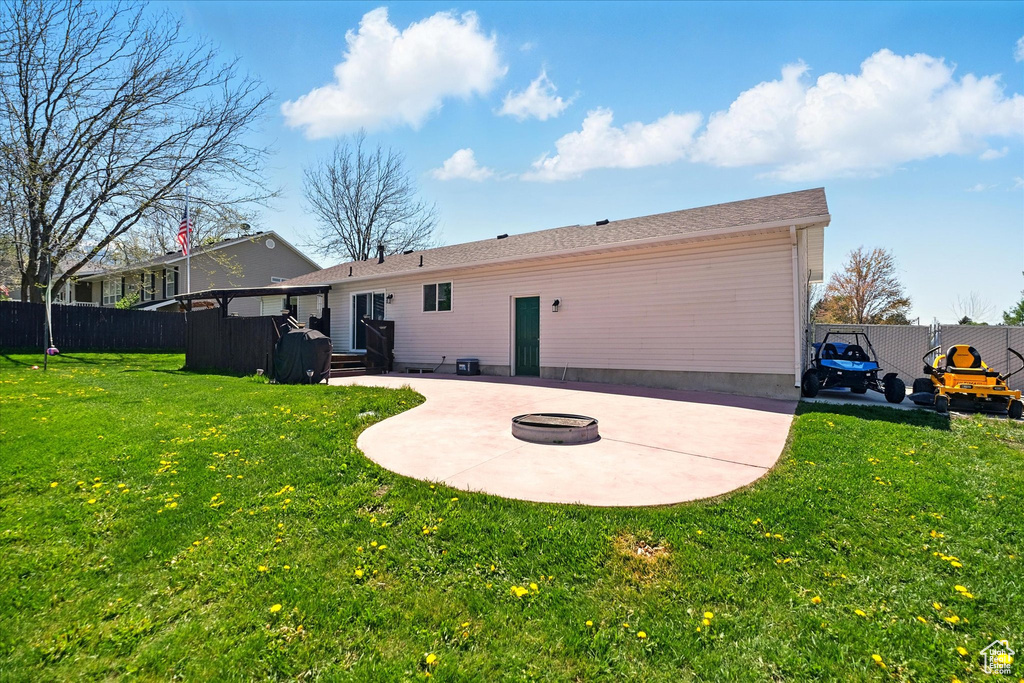 Back of property with a patio area and an outdoor fire pit
