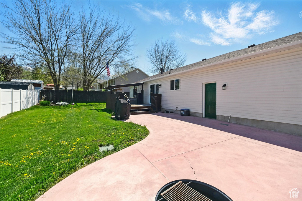 View of yard with a patio area and a wooden deck