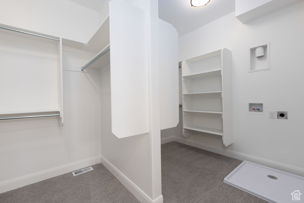 Walk in closet featuring carpet flooring