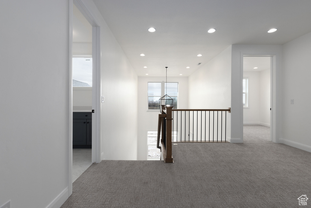 Hall featuring carpet, recessed lighting, an upstairs landing, and baseboards