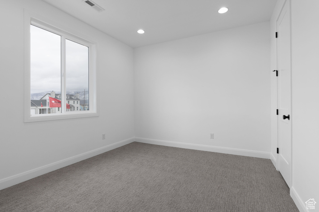 Spare room with carpet, recessed lighting, and baseboards