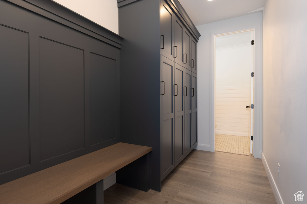 Mudroom with light wood-style floors and baseboards