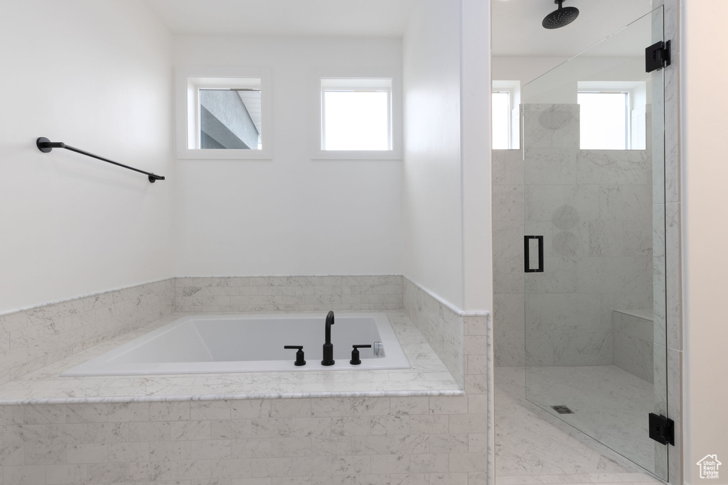 Bathroom with a stall shower and a bath