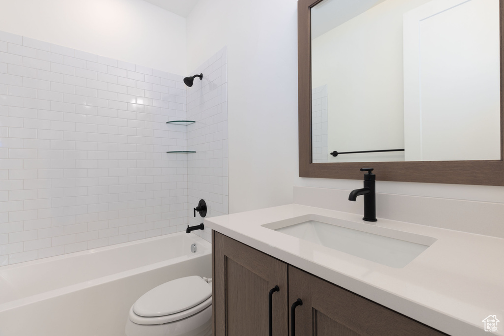 Full bath featuring toilet, vanity, and bathtub / shower combination