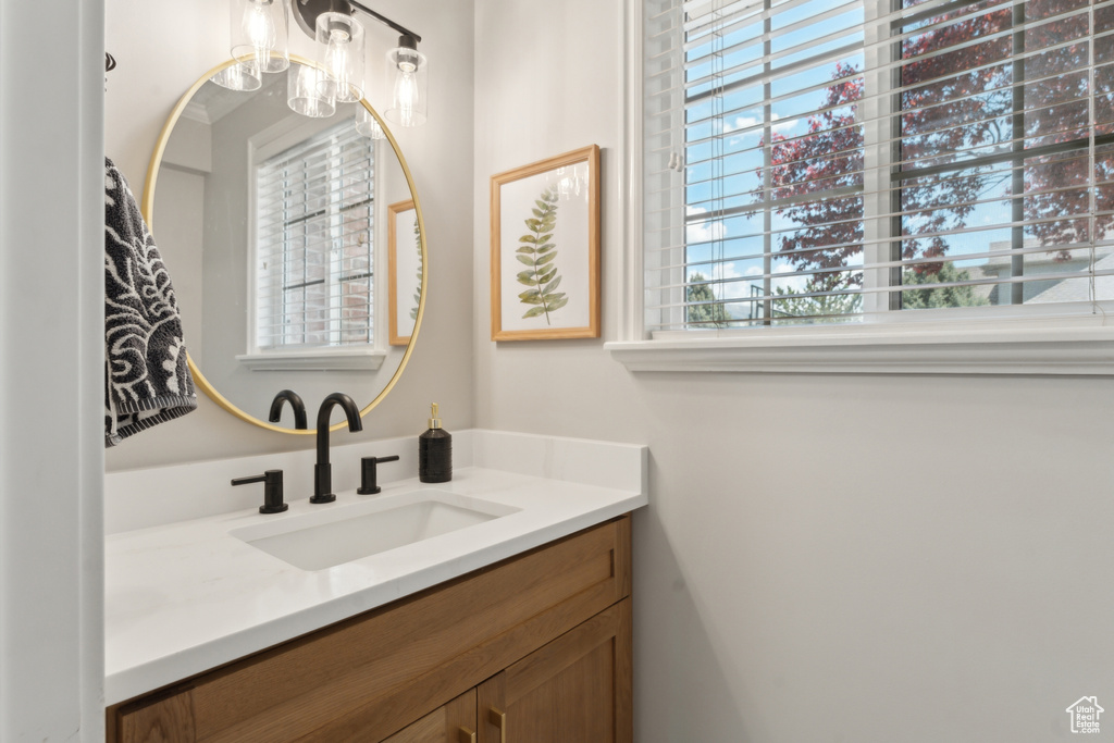 Bathroom featuring vanity and a chandelier