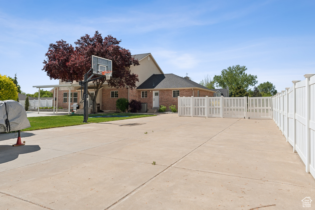 View of basketball court featuring fence and basketball court