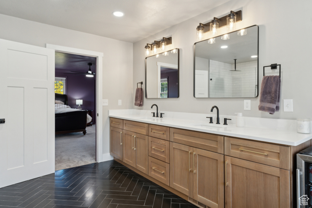 Full bathroom with double vanity, connected bathroom, and recessed lighting