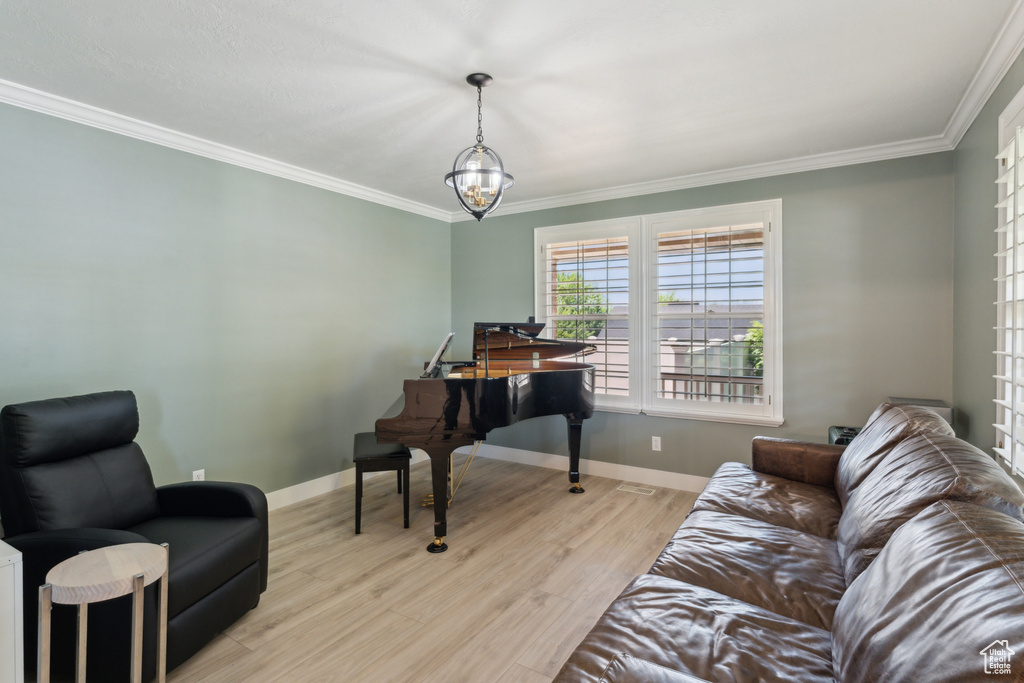 Office space with ornamental molding, a chandelier, wood finished floors, and baseboards