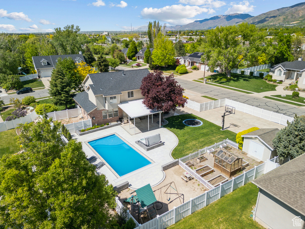Aerial view of residential area with a pool area and mountains