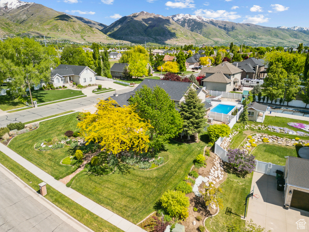 Aerial view of residential area with a pool area and mountains