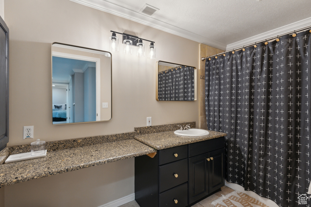 Bathroom featuring crown molding, curtained shower, vanity, and tile patterned floors