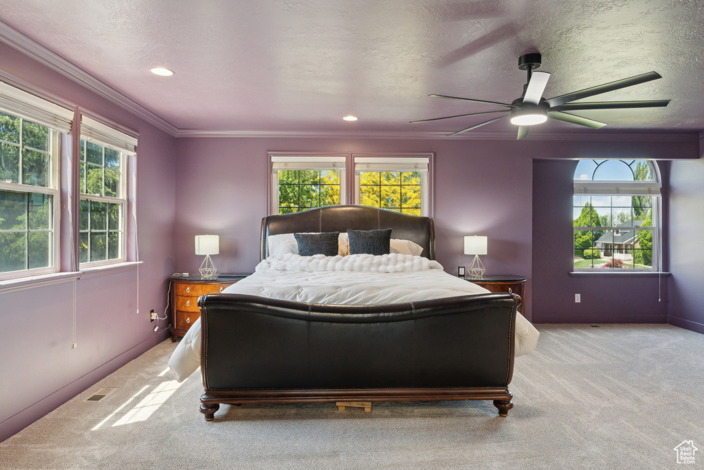 Carpeted bedroom featuring ornamental molding, recessed lighting, baseboards, and a ceiling fan
