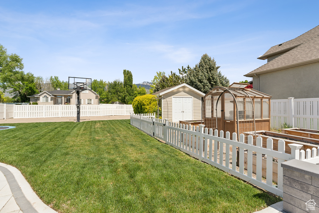 View of yard featuring an outdoor structure, a storage shed, a vegetable garden, and an exterior structure