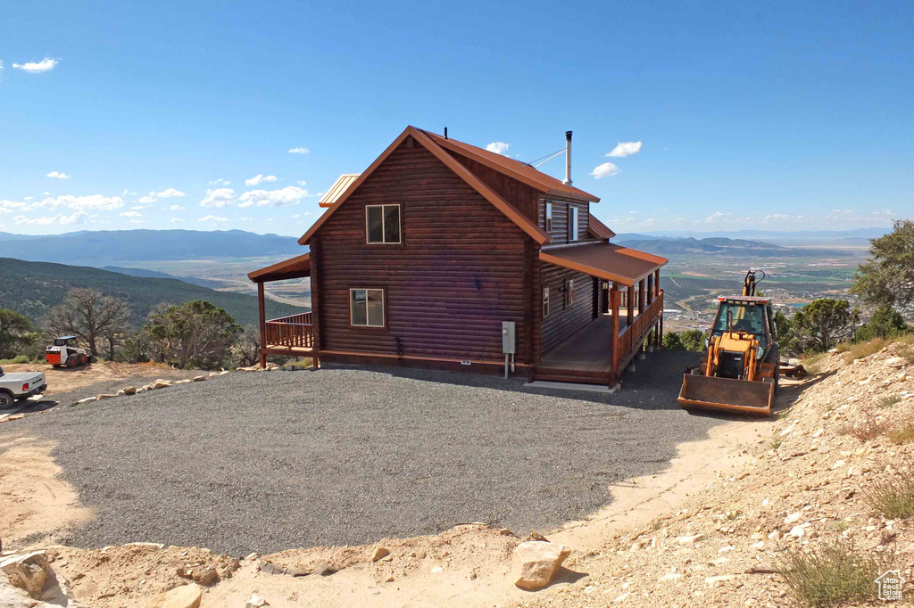 Rear view of property featuring a mountain view