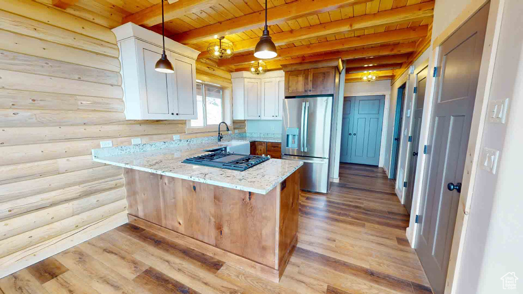 Kitchen with stainless steel refrigerator with ice dispenser, wood ceiling, black gas stovetop, light wood finished floors, and light stone countertops