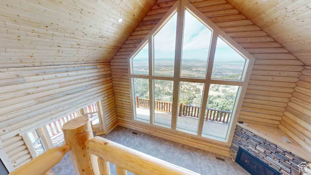 Bonus room with rustic walls, wooden ceiling, a fireplace, and lofted ceiling