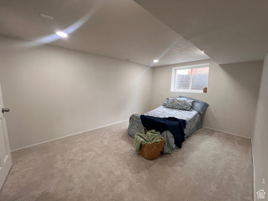 Bedroom featuring carpet flooring, vaulted ceiling, and recessed lighting