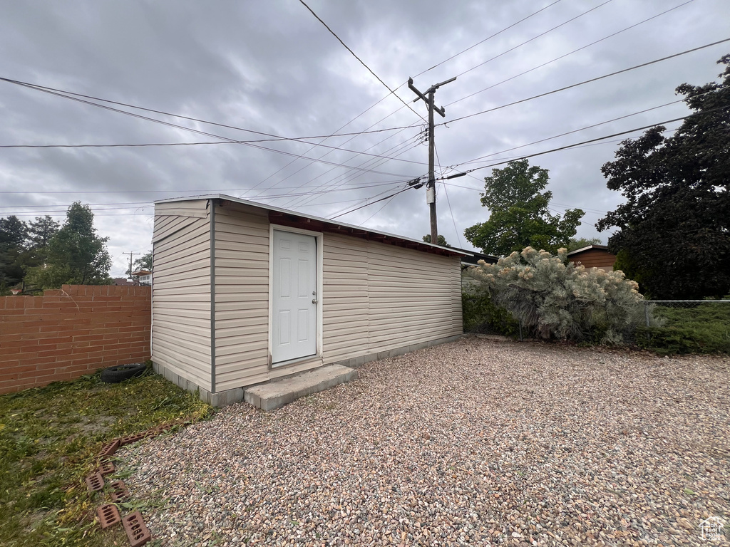View of outdoor structure with fence and an outdoor structure