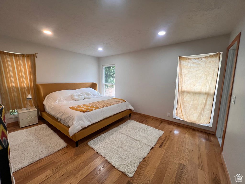 Bedroom with wood finished floors and recessed lighting
