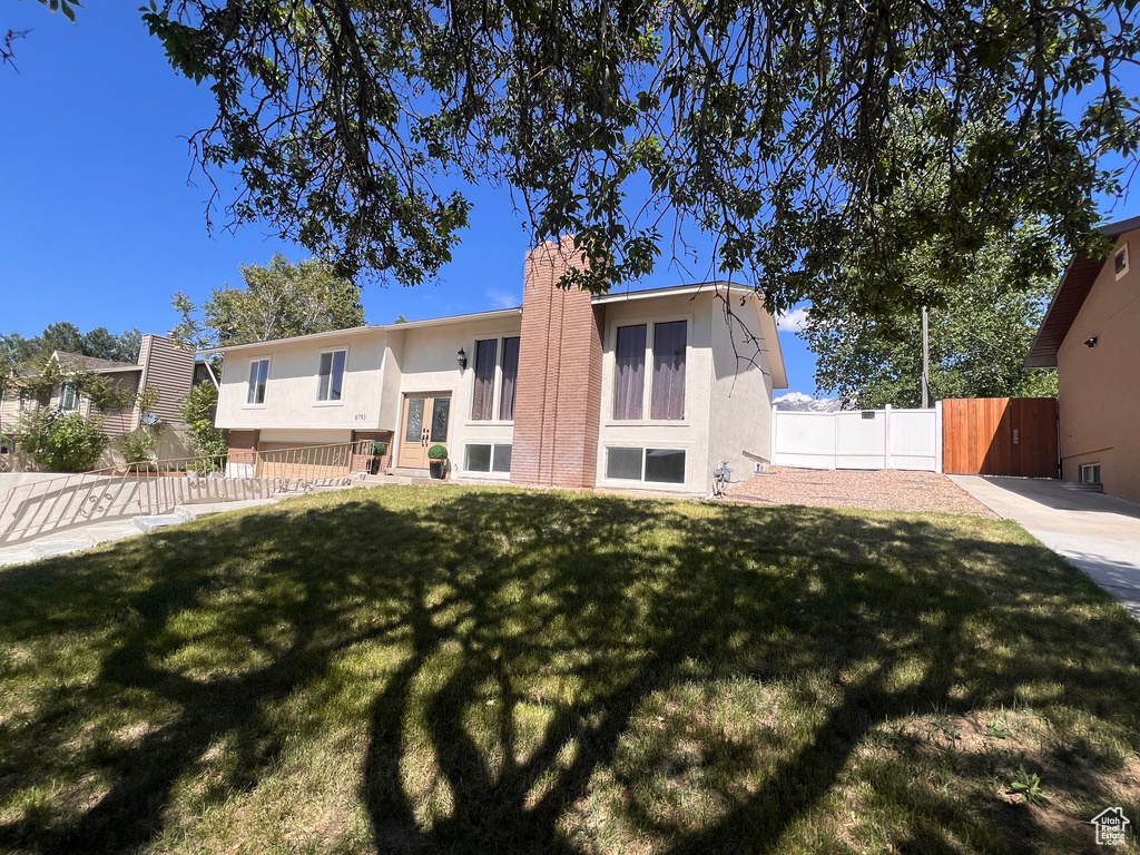 Rear view of property with stucco siding and a chimney