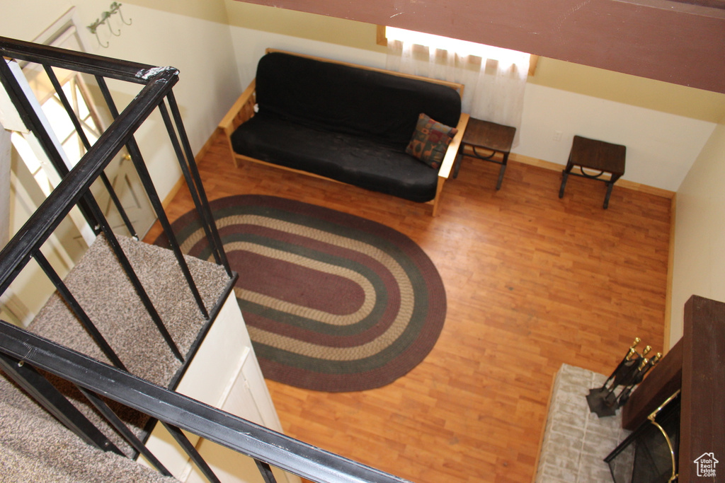Living area featuring wood finished floors, baseboards, and an upstairs landing