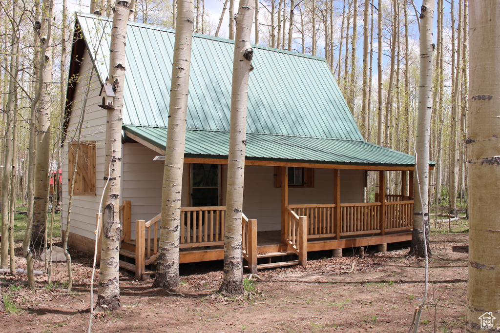 View of front of house with a porch and metal roof