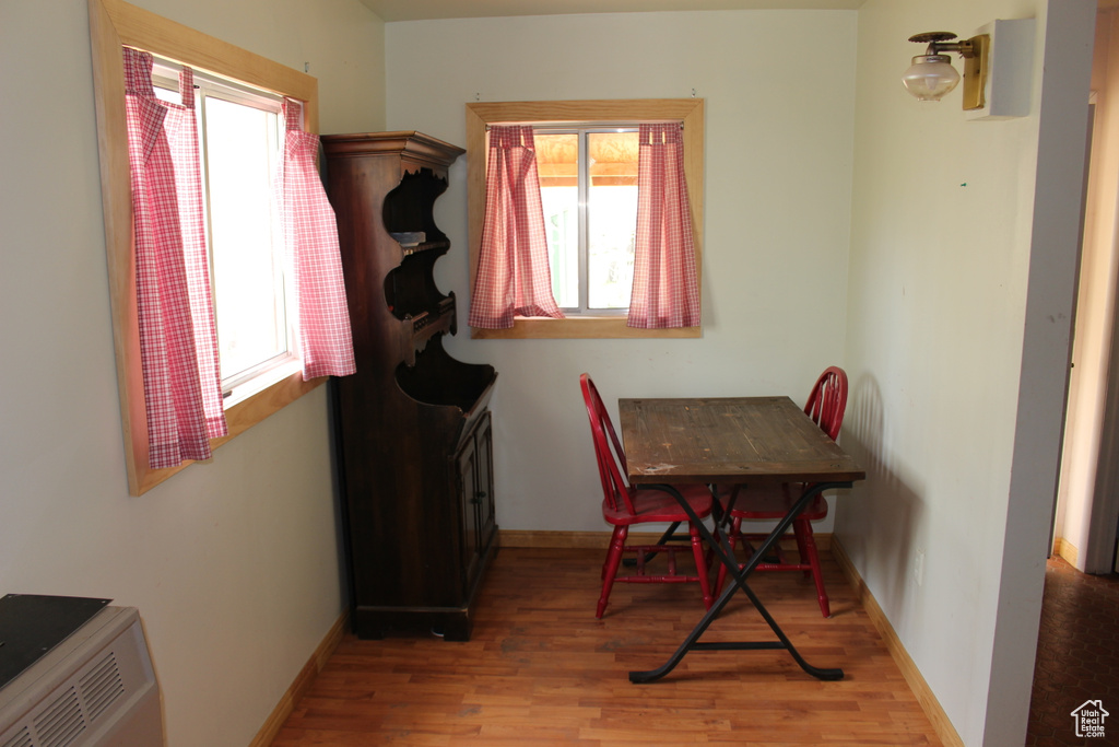 Dining room featuring healthy amount of natural light, wood finished floors, and baseboards