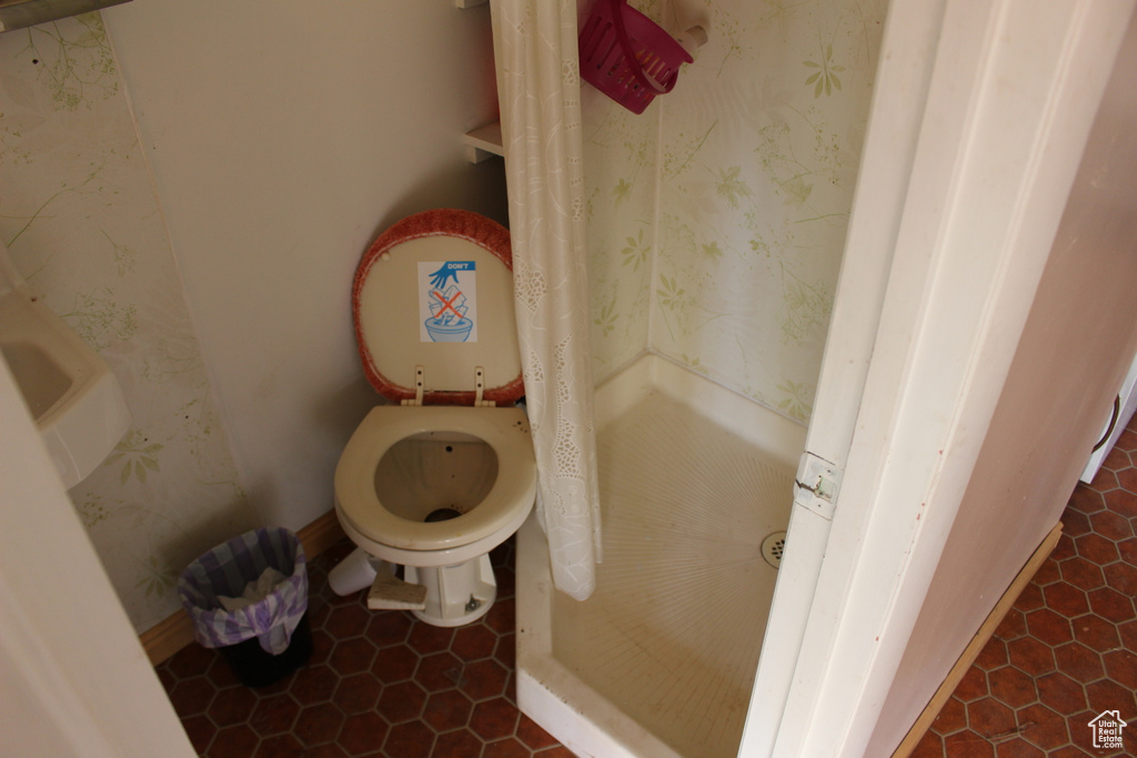 Bathroom featuring tile patterned flooring and toilet