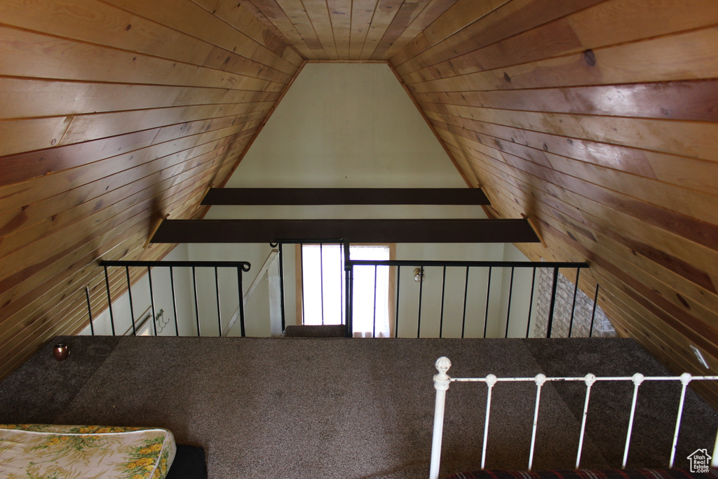 Bonus room with wood walls and vaulted ceiling
