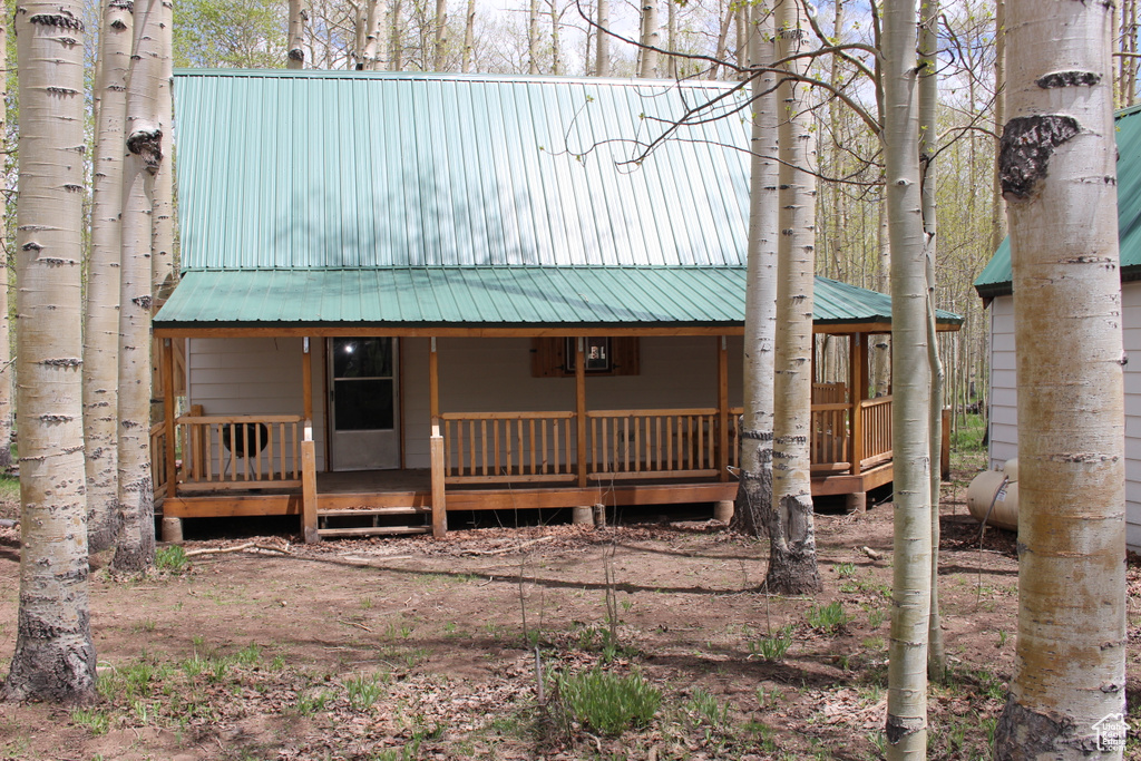 View of front facade featuring a porch and metal roof