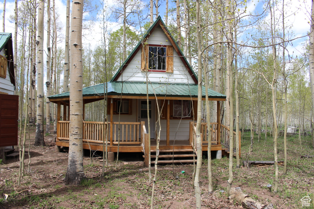 View of front of property with metal roof and a porch