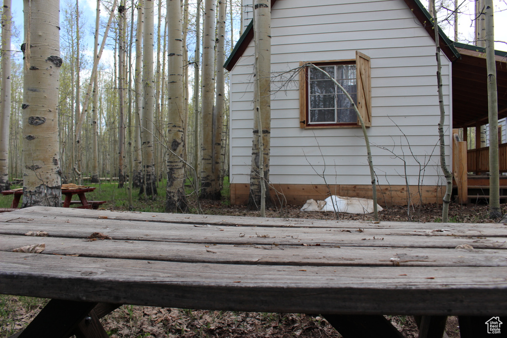 View of side of property featuring a wooden deck