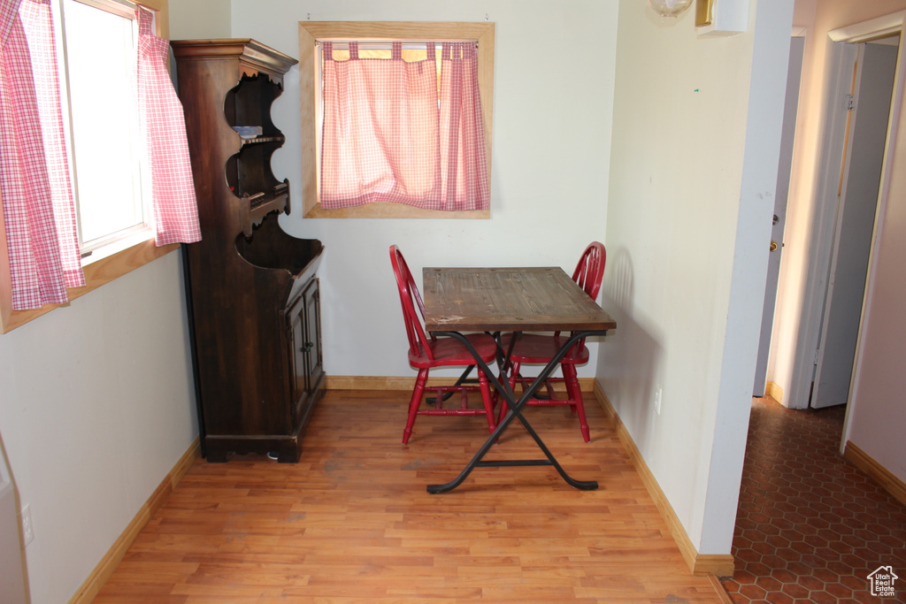 Dining space with light wood-style flooring and baseboards