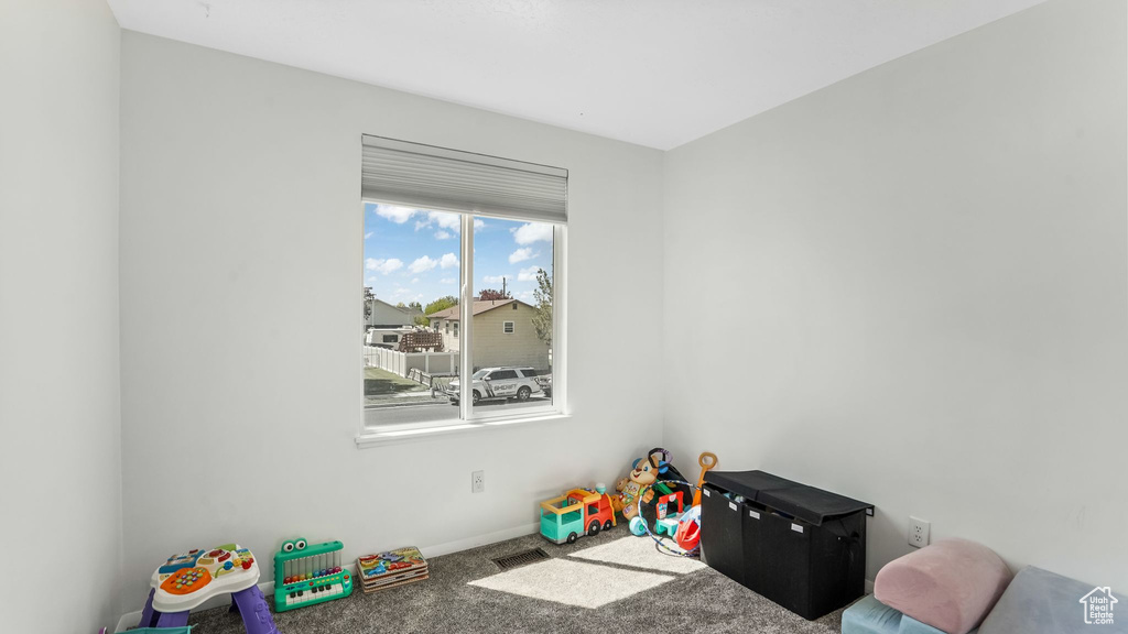 Game room featuring carpet floors and baseboards