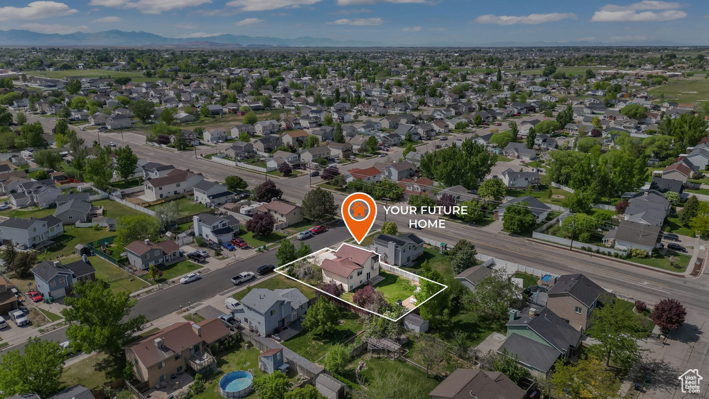 Aerial view of residential area featuring property parcel outlined and mountains