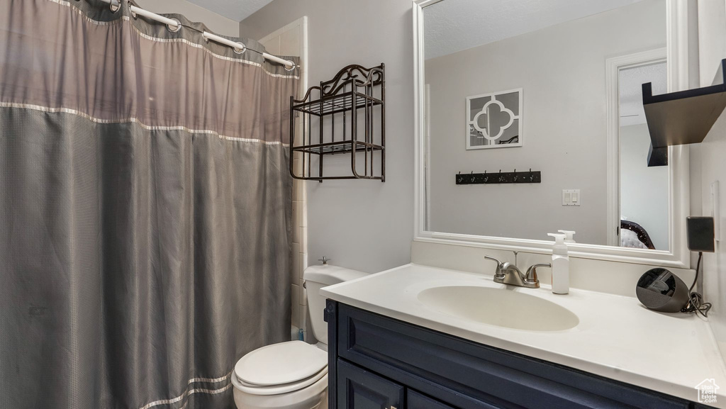 Full bathroom with vanity and toilet