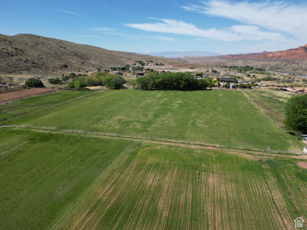 Aerial view of property's location with rural landscape and a mountainous background