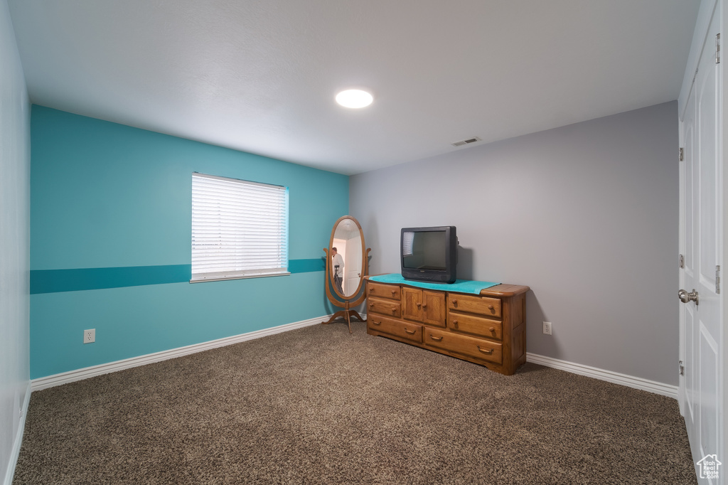 Carpeted bedroom with baseboards