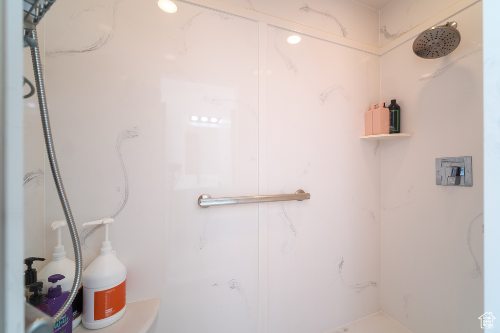 Bathroom featuring a marble finish shower