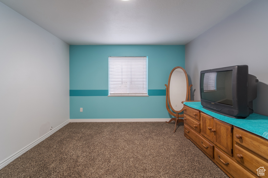Carpeted bedroom featuring baseboards