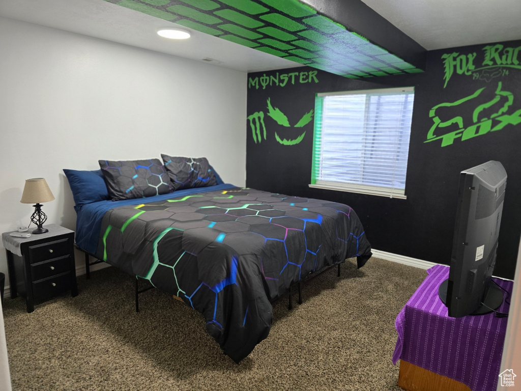 Bedroom featuring carpet and baseboards